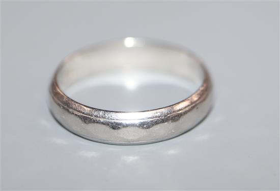 A white metal band stamped platinum, size K/L.